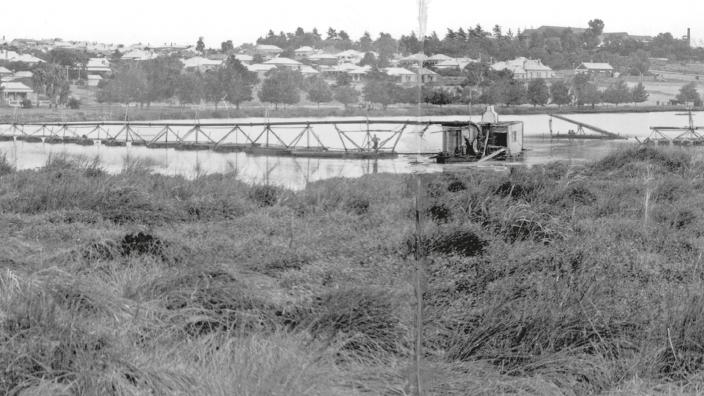 Black and white photograph of lake and bushland surrounding it 